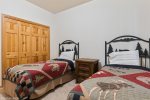 This room features a large closet & two twin beds 